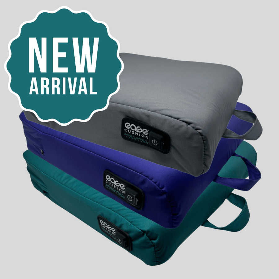 A stack of new Ease Cushion covers in gray, blue, and teal showcases its integrated handle and power button.
